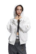 Medium shot of a model wearing the hood up on a heather light grey full zip hoodie sweatshirt.