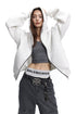 Front shot of a model raising hands to hood on an unzipped heather grey boxy hoodie jacket.