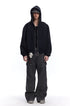 Front full body shot of a male model wearing a black full-zip oversized hoodie jacket with hood up.