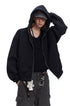 Three-quarter view of a male model wearing a black relaxed fit hooded zip jacket.