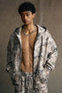 model front view wearing branch camo zip hoodie with sweatpants
