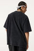 Back view of vintage black "Breakthrough" tee worn by model.