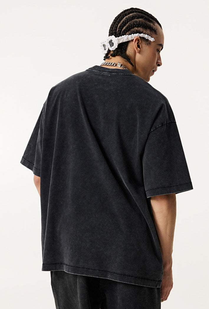 Back view of vintage black "Breakthrough" tee worn by model.