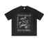 Flat lay of vintage black "Breakthrough" tee with koi fish and compass graphic.