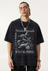 Side angle of model in vintage black "Breakthrough" tee showing graphic.