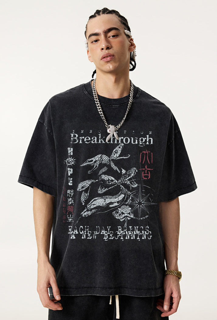 Side angle of model in vintage black "Breakthrough" tee showing graphic.