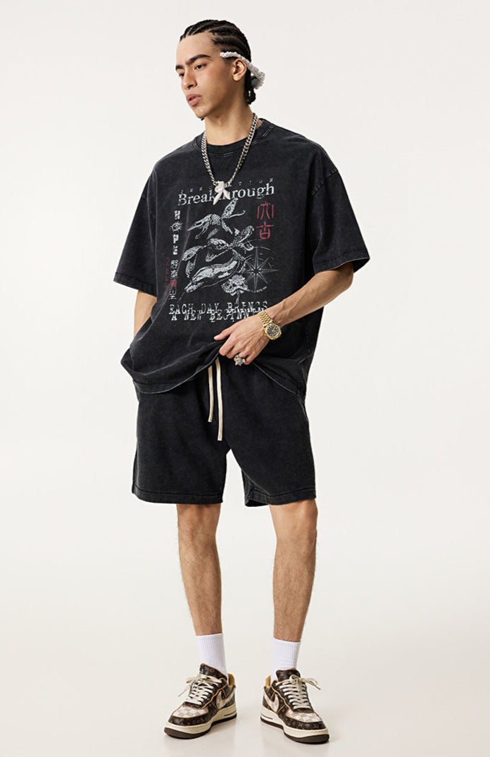 Model wears vintage black "Breakthrough" tee with matching shorts and sneakers.
