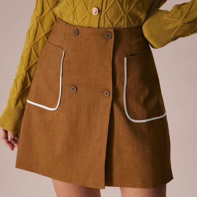 brown a-line skirt with white trim pockets front detail