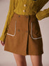 brown a-line skirt with white trim pockets front detail
