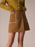 brown button mini skirt close-up with contrast pockets
