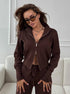 Close view of brown knit 2 piece outfit featuring wide leg pants and zip jacket