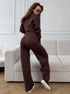 Back view of woman in brown 2 piece knit set with zip jacket and pants indoors