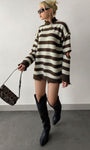 model wearing brown striped quarter zip sweater with knee boots in streetwear look