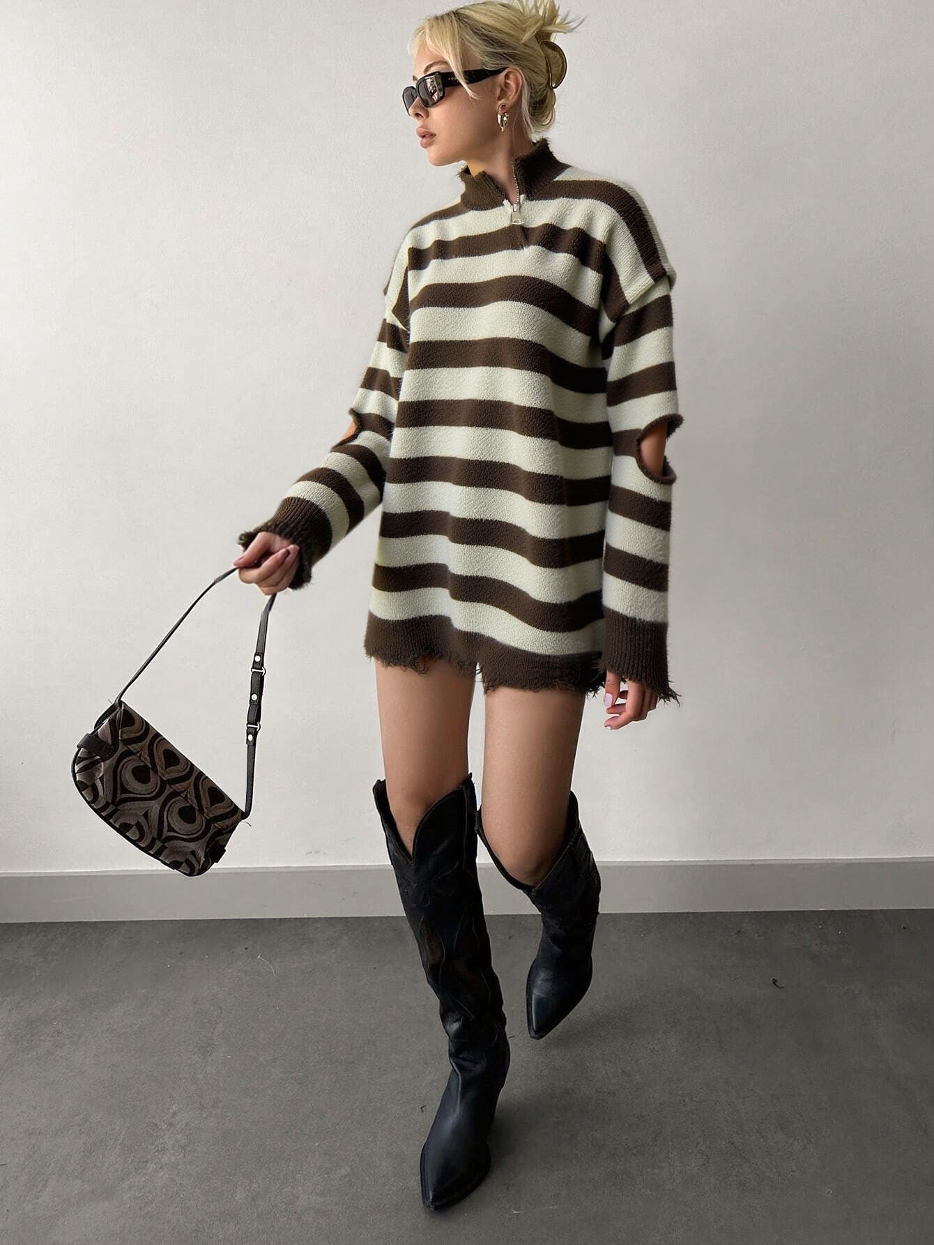 model wearing brown striped quarter zip sweater with knee boots in streetwear look