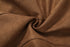 Close-up of brown fabric with folds