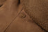 close-up of brown suede jacket double-button detail