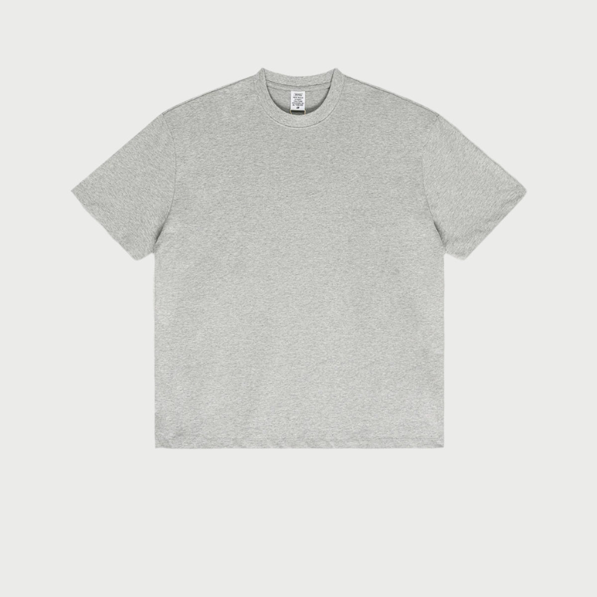 Light heather gray oversized t-shirt displayed flat against light gray background with branded tag visible