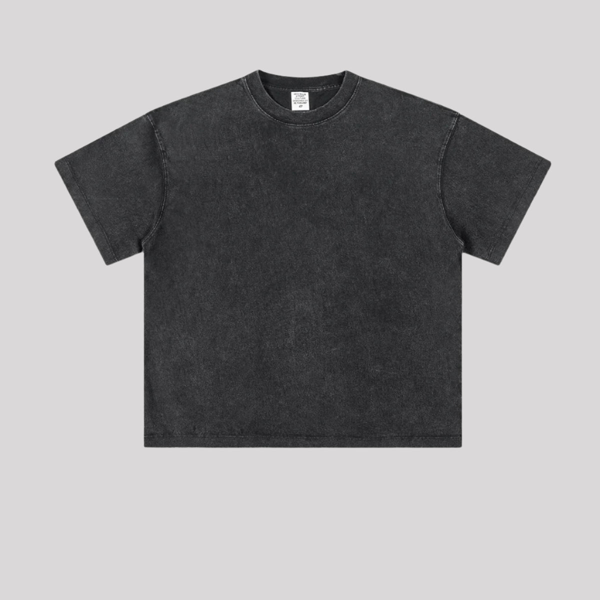 Plain black washed oversized t-shirt with crew neckline shown flat against light gray background, back view