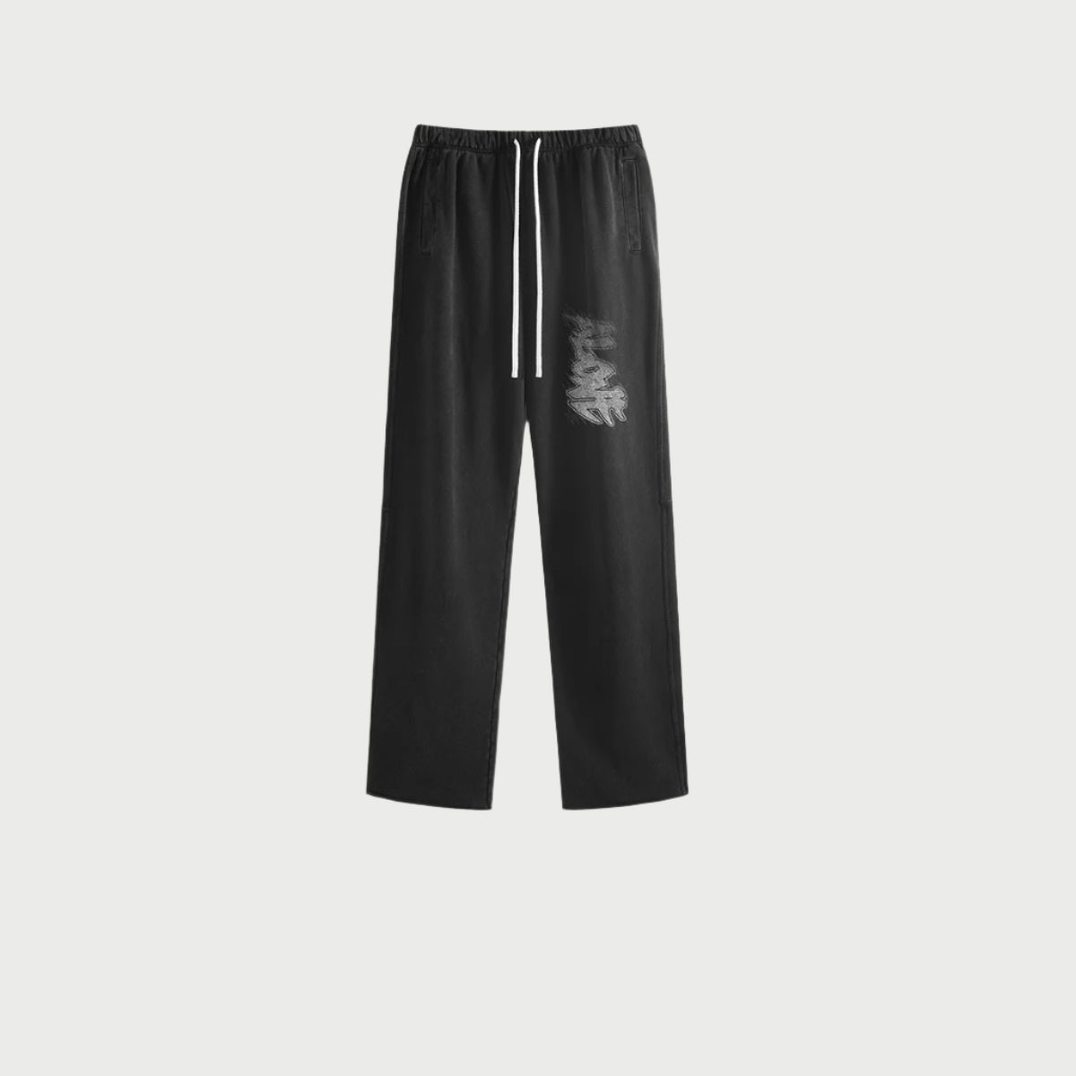 Black sweatpants displayed flat showing elastic waistband, white drawstring, side pockets and streetwear graphic detail