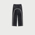 Full product shot of black washed denim track pants with twin gray side stripes and relaxed wide-leg fit