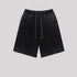 Black washed cotton shorts with drawstring waist and side pockets displayed flat against light gray background