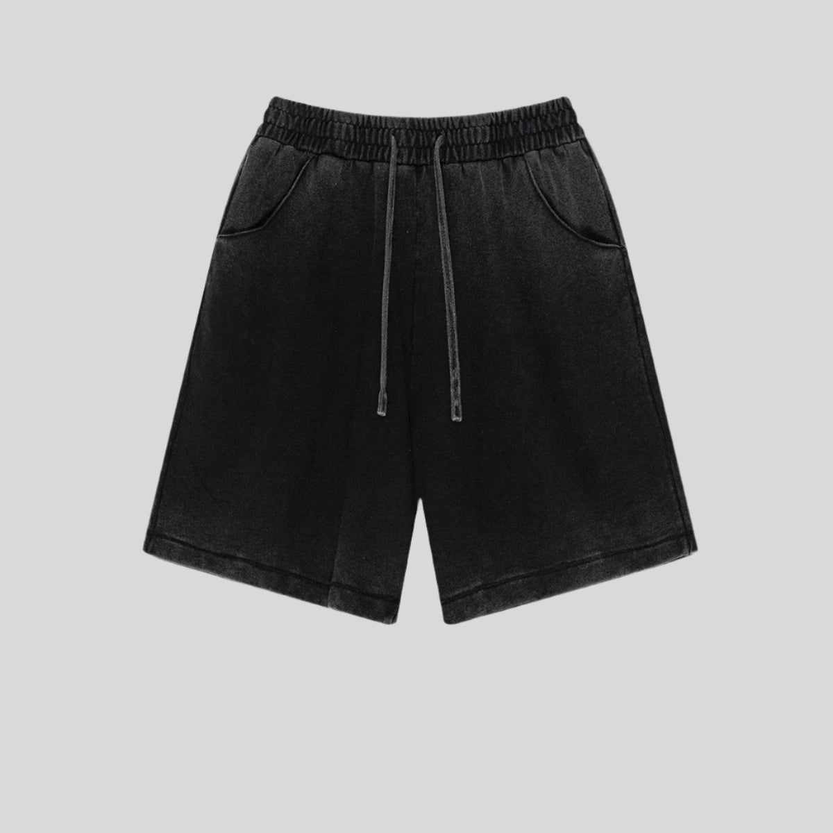 Black washed cotton shorts with drawstring waist and side pockets displayed flat against light gray background