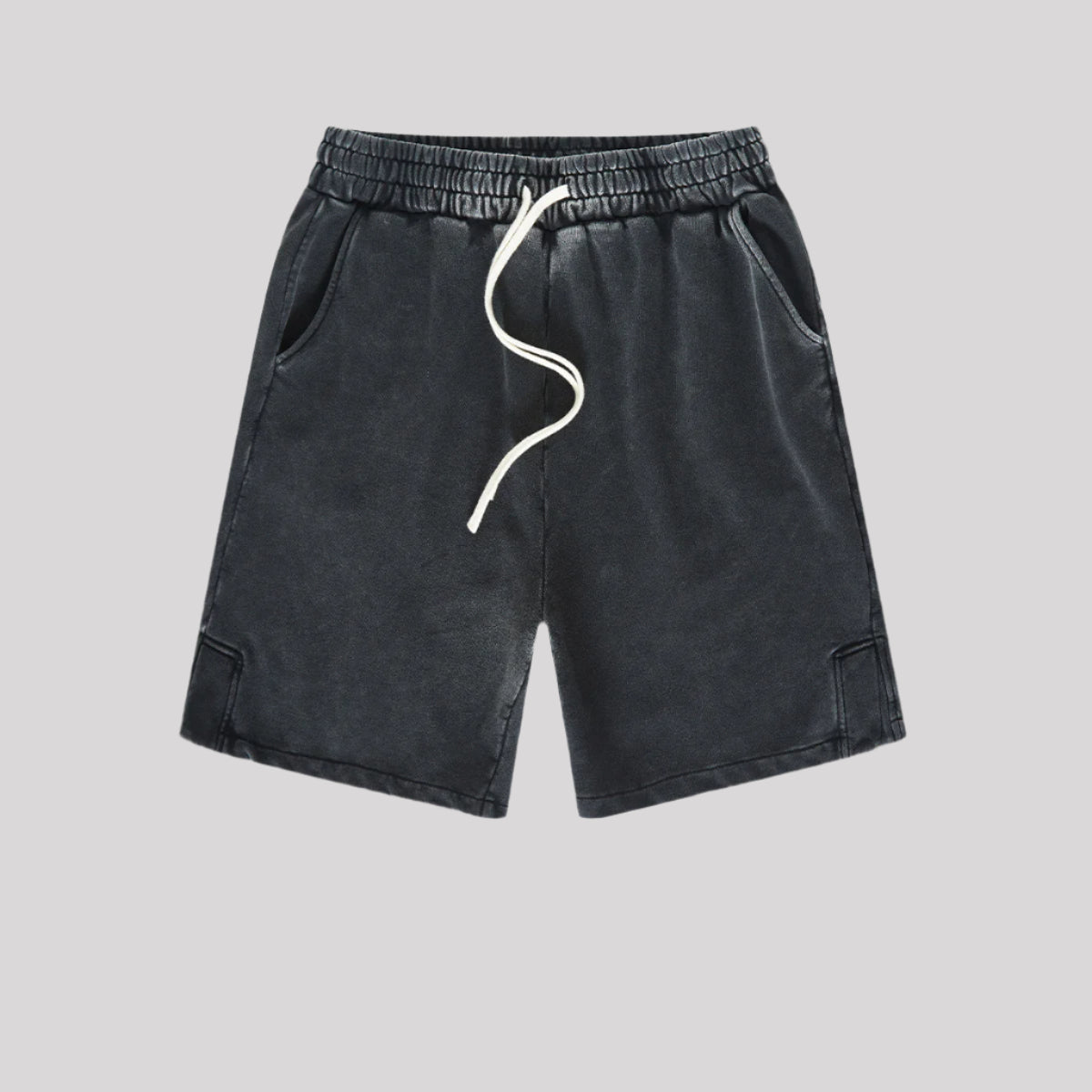 A pair of black washed drawstring shorts with a soft, vintage-inspired fabric, elastic waistband, and white drawstrings