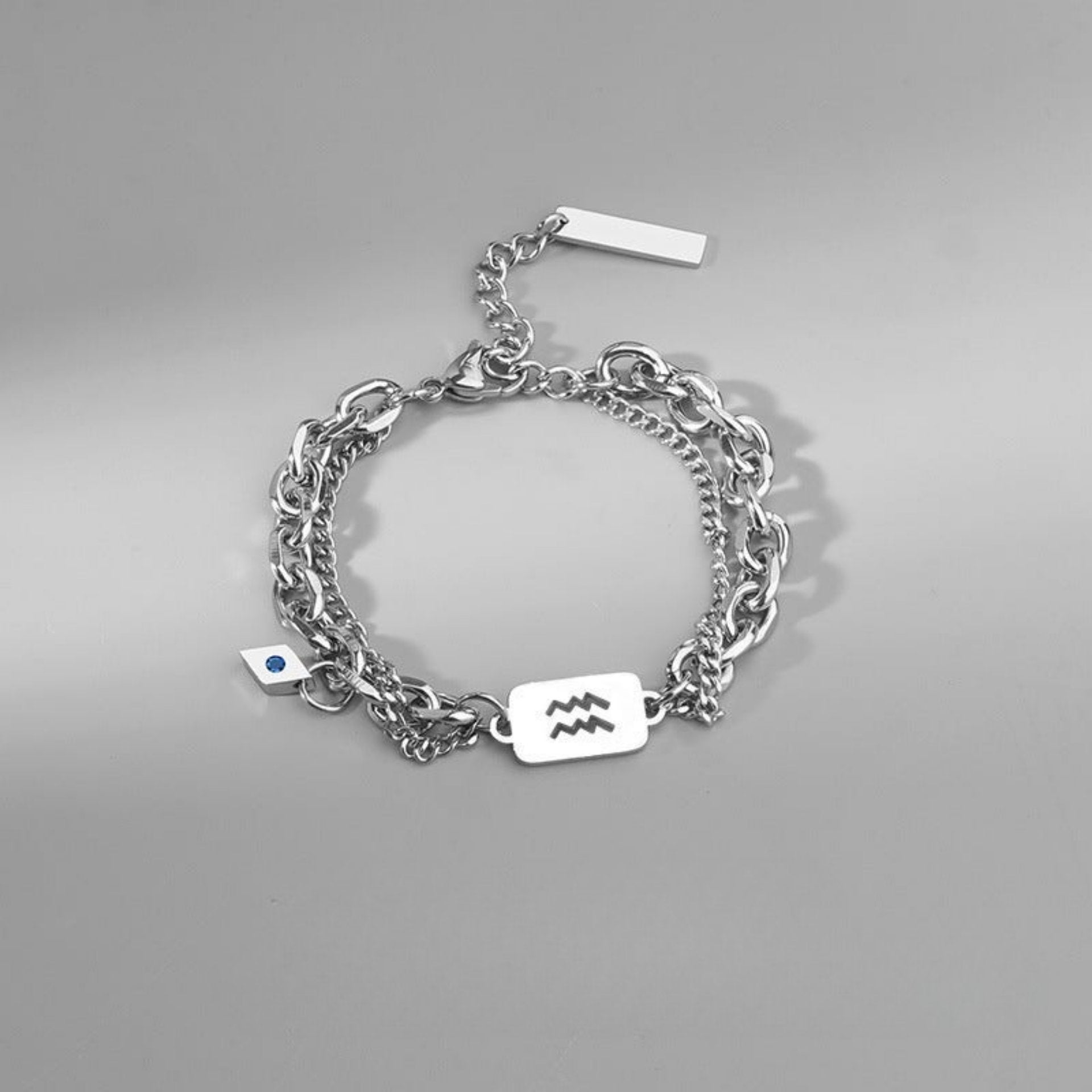 Aquarius zodiac bracelet in stainless steel, designed with layered chains and an engraved charm for a sleek look.