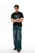 Full-length streetwear outfit featuring black chain graphic T-shirt and relaxed denim