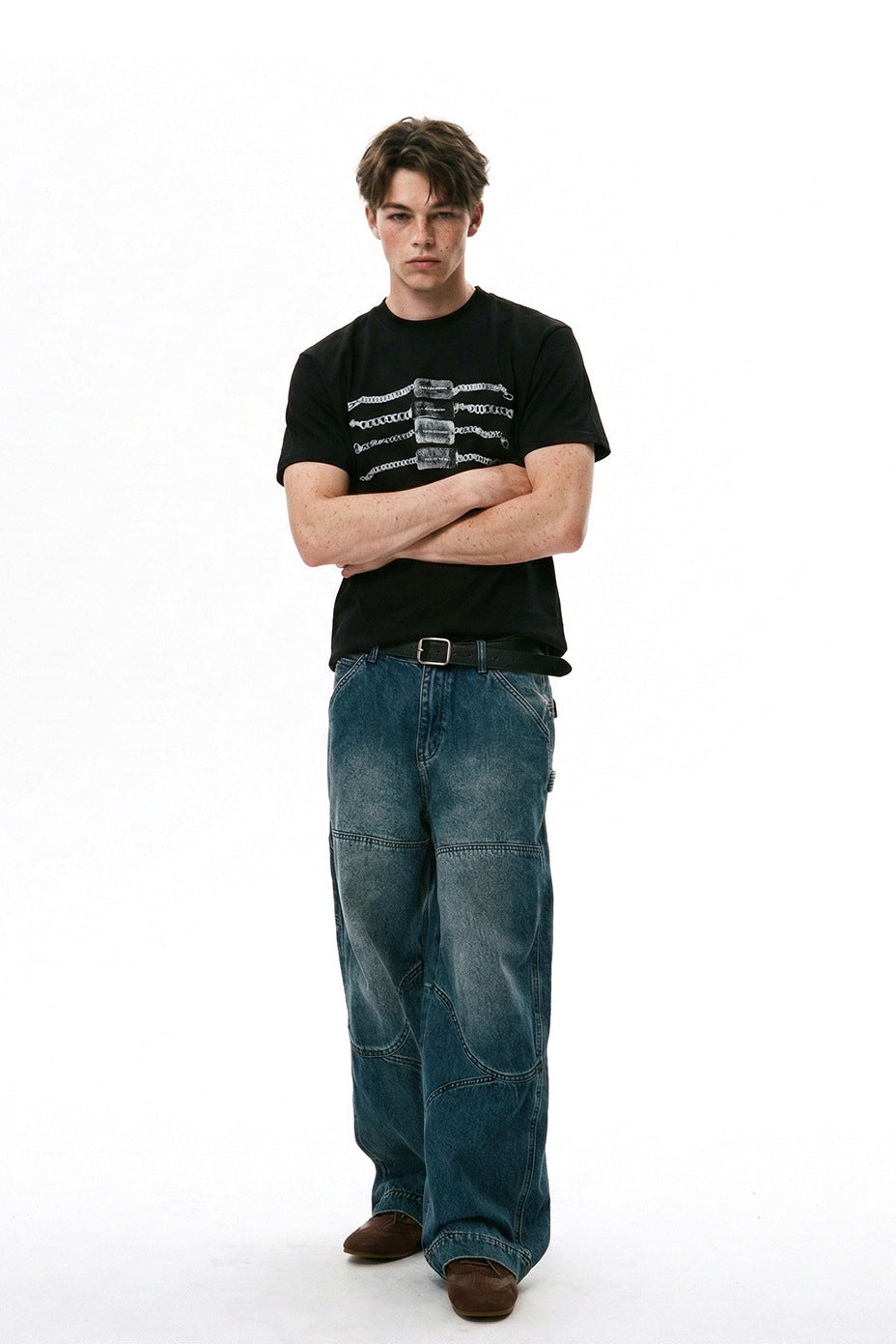 Full-length streetwear outfit featuring black chain graphic T-shirt and relaxed denim