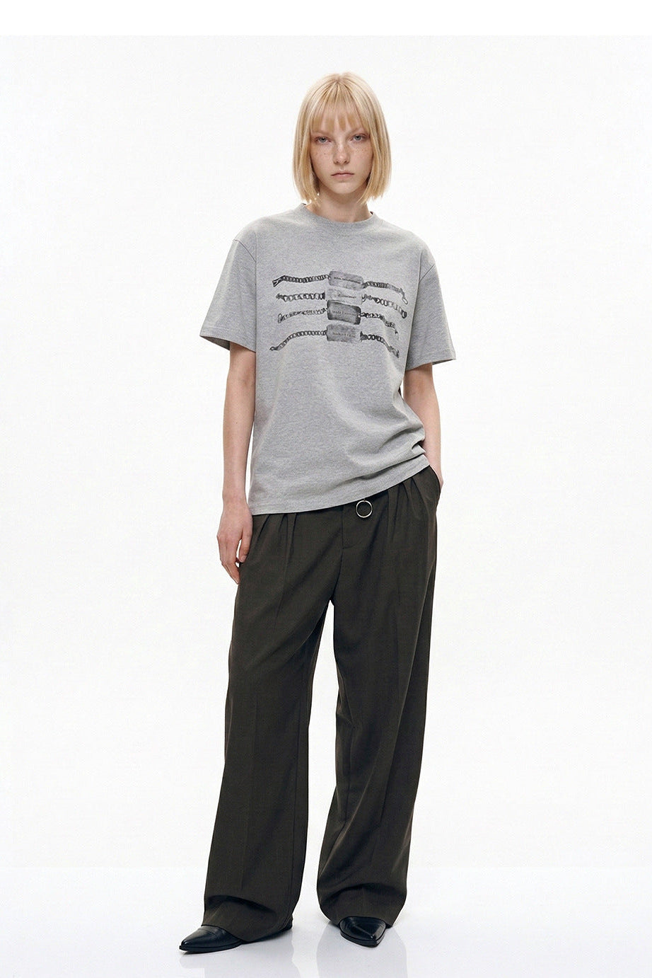 Front full-length view of relaxed heather gray chain graphic T-shirt with tailored pants