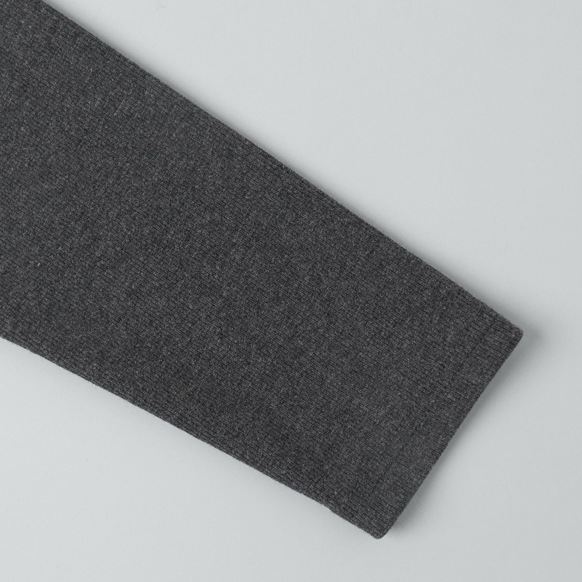 close-up of charcoal ribbed cardigan sleeve