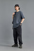 Unisex charcoal oversized tee, black shorts, studio shot
