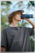 Male model in charcoal oversized tee with binoculars