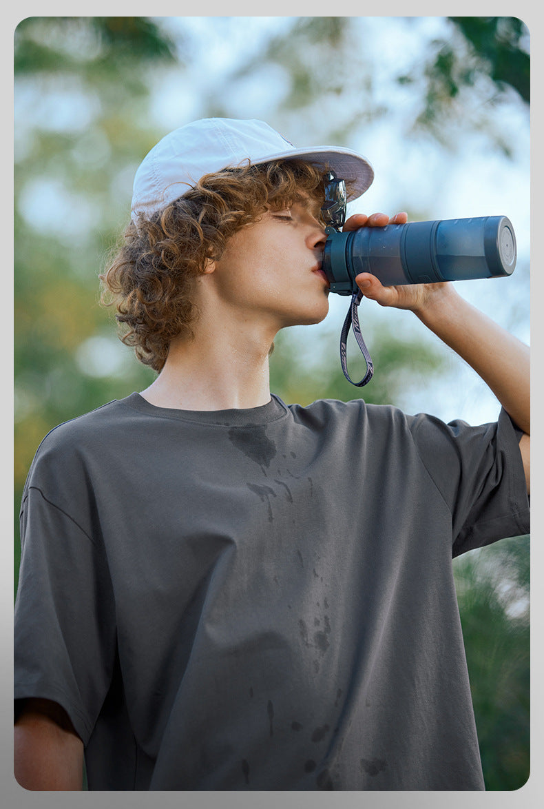 Male model in charcoal oversized tee with binoculars