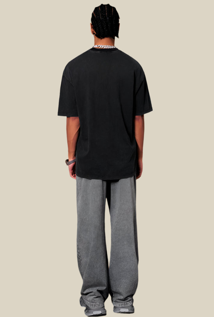 Back view of man wearing black pixel tee with washed texture and relaxed fit