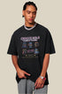 Model pointing to hem of pixel tee, styled with grey washed pants