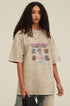 Woman in khaki Choose Role tee holding black tee in hand