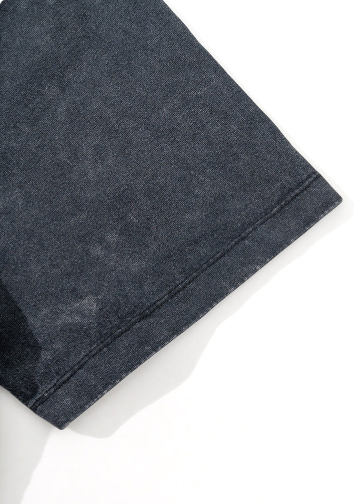 Close-up of black tee sleeve showing neat double stitching