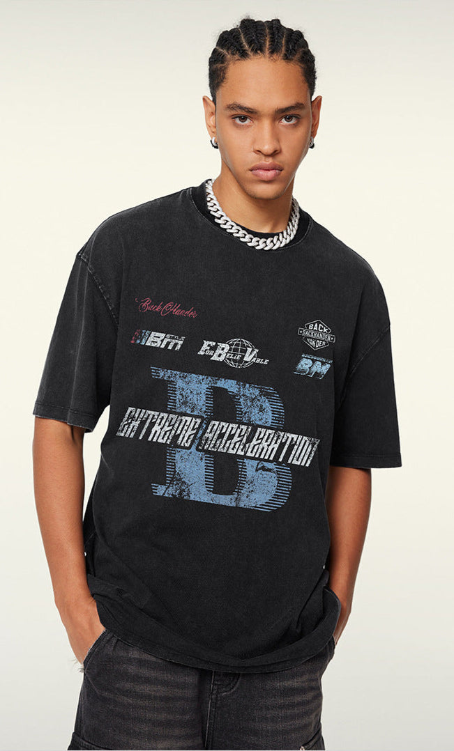 Close-up of black tee showcasing distressed "B" and racing text.

