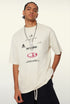 Close-up of model in cream tee showing bold chest graphic