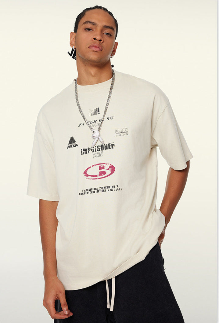 Close-up of model in cream tee showing bold chest graphic