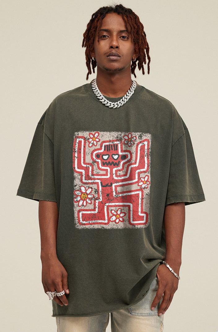 Front close-up of model wearing olive green tee with red skeleton and flowers.