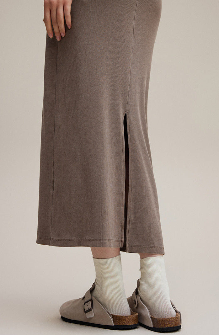 Coffee brown long sleeve bodycon dress, close-up of side slit at hem