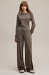 Model in coffee long sleeve tee paired with wide leg pants full look