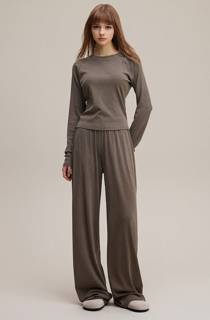 Model in coffee long sleeve tee paired with wide leg pants full look