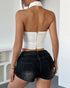 Back view of white strapless corset top with halter collar and zip-up closure.