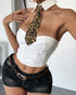 White strapless corset top with leopard tie, black denim shorts, and leopard belt.