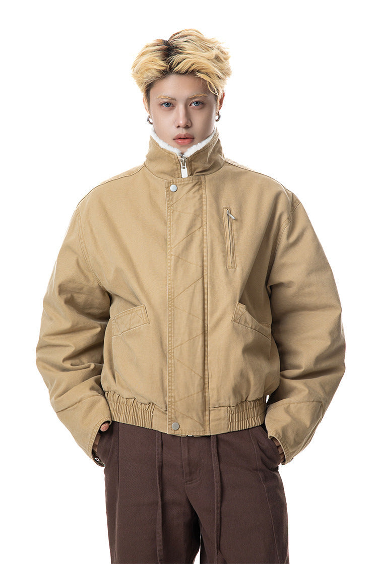 Medium shot of men's khaki winter canvas jacket highlighting chest zip pocket and snap placket.