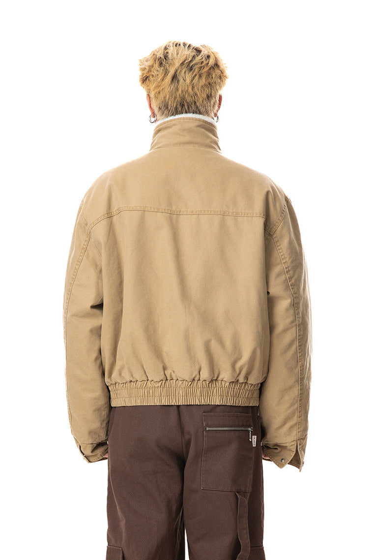 Rear view of khaki canvas winter jacket showing back yoke, high collar, and elasticated waist.